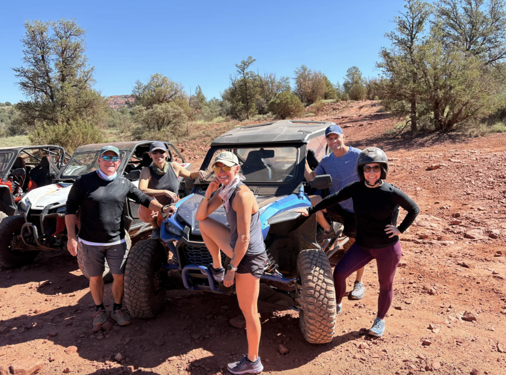 Is March a Good Time to Rent a UTV in Sedona? 2 Group of riders posing in front of the UTV, enjoying Sedona’s red rock views