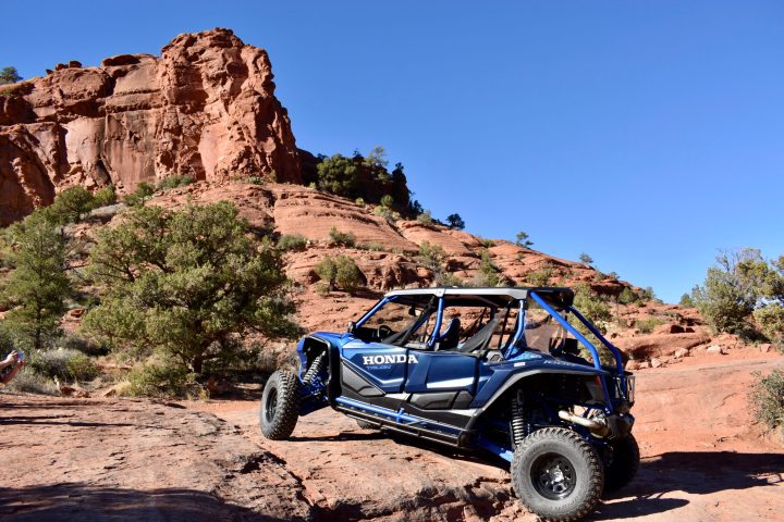 a UTV driving down a dirt road