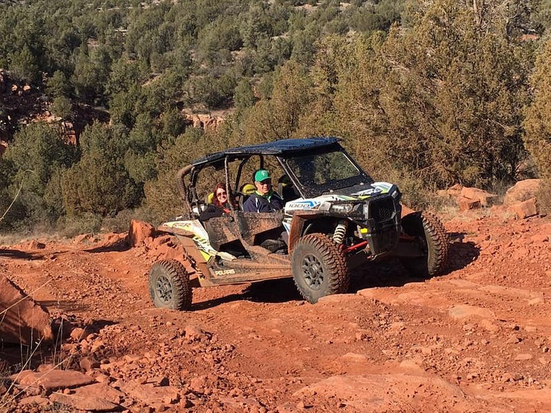 A rugged off-road vehicle navigating through red rock formations in Sedona, Arizona